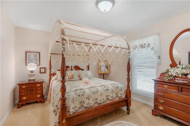 bedroom with light carpet and a textured ceiling