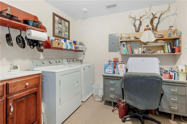 laundry area featuring electric panel, cabinets, light colored carpet, independent washer and dryer, and a textured ceiling