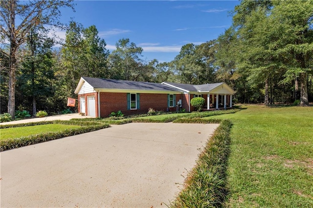 single story home with a garage and a front lawn