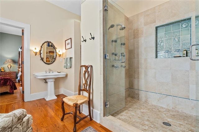 bathroom featuring hardwood / wood-style floors and an enclosed shower