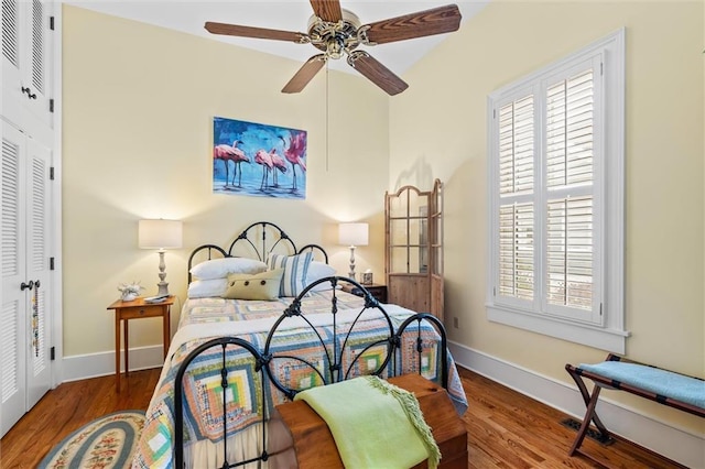 bedroom with a closet, ceiling fan, and hardwood / wood-style flooring