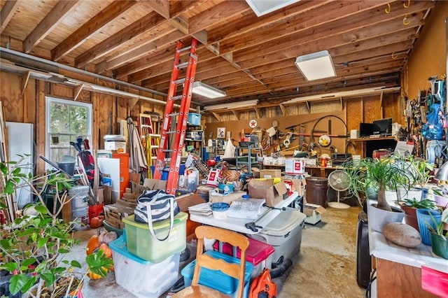 garage with refrigerator and a workshop area