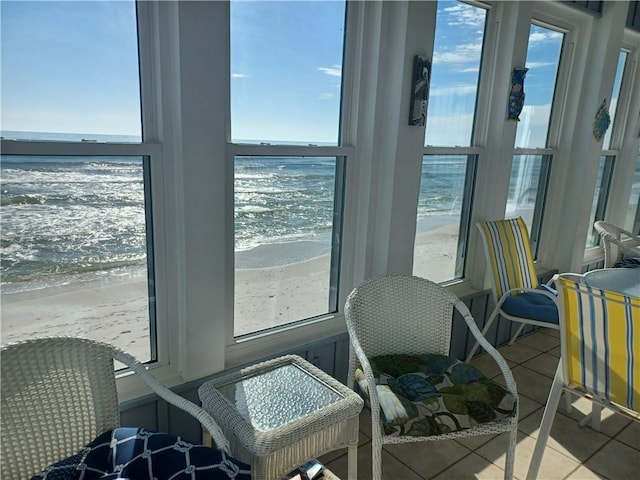 interior space featuring a beach view, a water view, and plenty of natural light