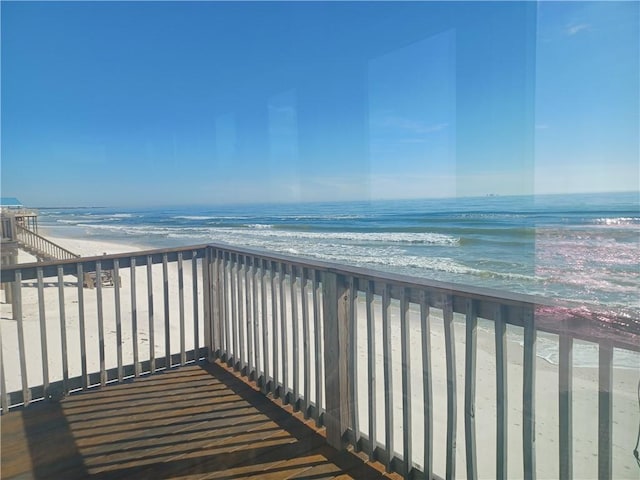 balcony with a water view and a beach view