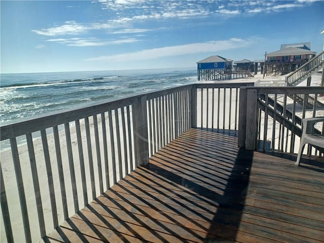 deck with a beach view and a water view