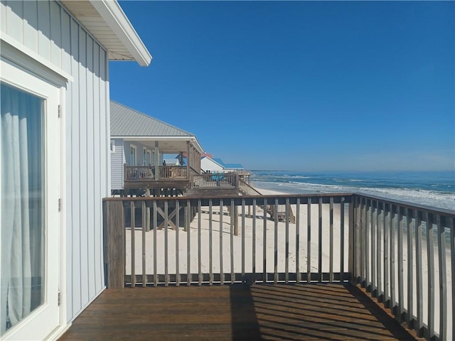 balcony with a beach view and a water view