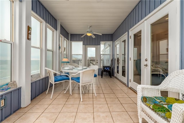 sunroom / solarium featuring ceiling fan