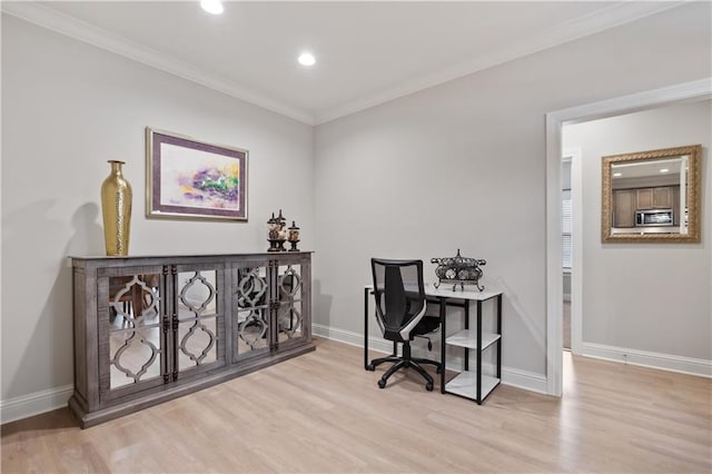 home office featuring ornamental molding and light hardwood / wood-style flooring