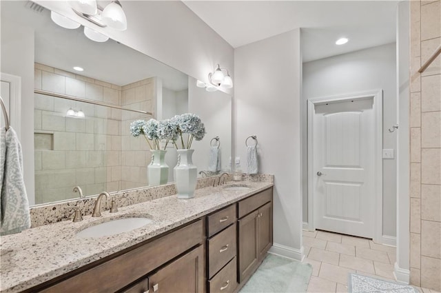 bathroom featuring an inviting chandelier, tile patterned flooring, a shower with shower door, and vanity