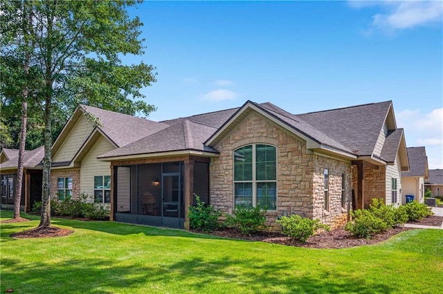 view of front of house featuring a sunroom and a front lawn