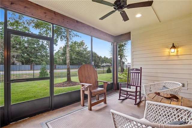 sunroom / solarium featuring ceiling fan