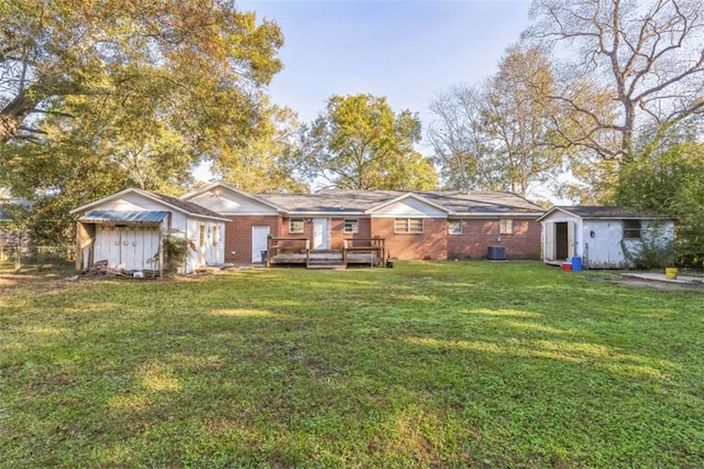 view of front of house featuring a wooden deck, central AC, a front yard, and a storage unit