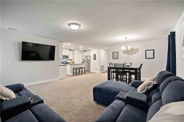 carpeted living room with a chandelier and a textured ceiling