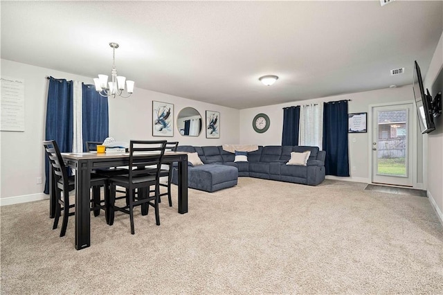 dining room featuring light carpet and an inviting chandelier