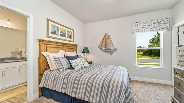 2260 Nadine Ln, Mobile, AL 36695 - bedroom featuring baseboards, ensuite bath, and light colored carpet
