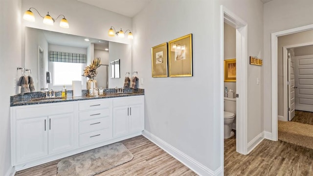 2260 Nadine Ln, Mobile, AL 36695 - full bath with double vanity, wood finished floors, baseboards, and toilet