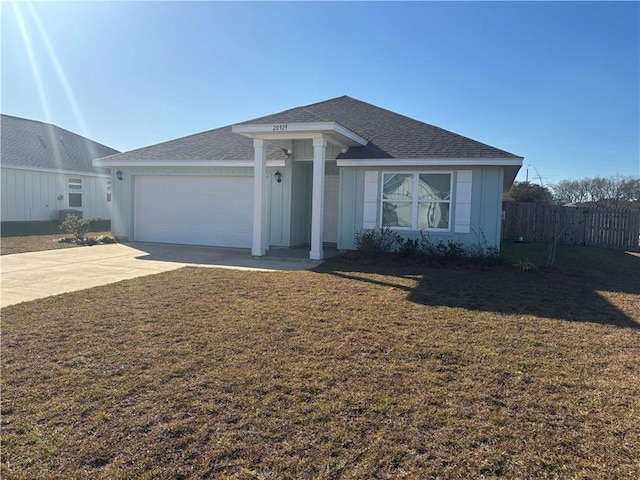 single story home featuring a front yard and a garage