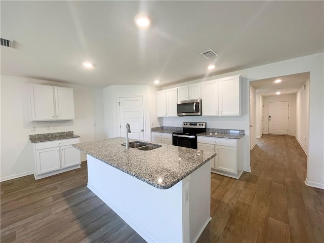 kitchen with white cabinetry, sink, stainless steel appliances, dark hardwood / wood-style floors, and a center island with sink