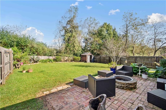 view of patio with an outdoor living space with a fire pit and a storage shed