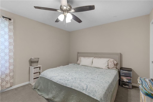 bedroom featuring light colored carpet, ceiling fan, and baseboards