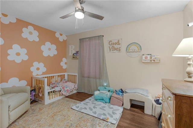 bedroom with a ceiling fan and wood finished floors