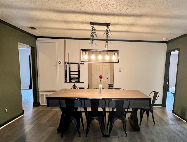 dining space featuring ornamental molding, a textured ceiling, and dark hardwood / wood-style flooring