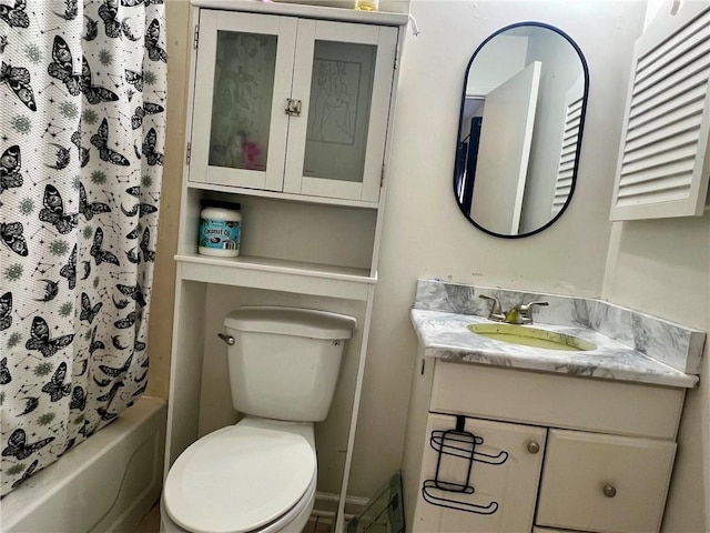 full bathroom with vanity, shower / tub combo, and toilet