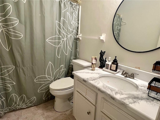 bathroom featuring vanity, toilet, and tile patterned flooring