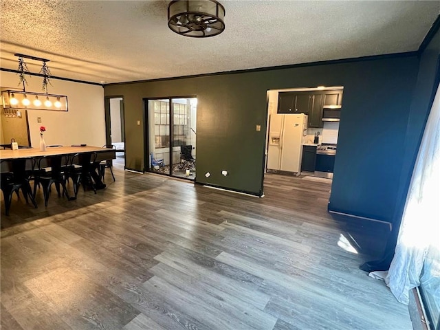 dining room featuring crown molding, dark hardwood / wood-style floors, and a textured ceiling