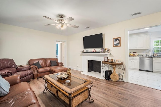 living room with ceiling fan and light tile flooring