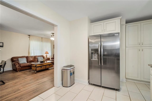 kitchen featuring white cabinetry, light hardwood / wood-style floors, ceiling fan, and stainless steel refrigerator with ice dispenser