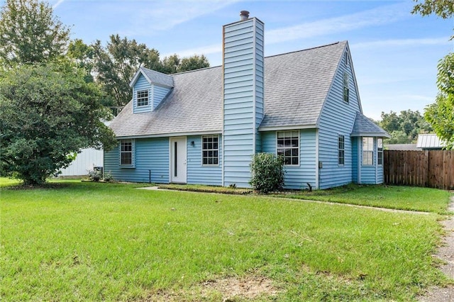 rear view of property with a lawn