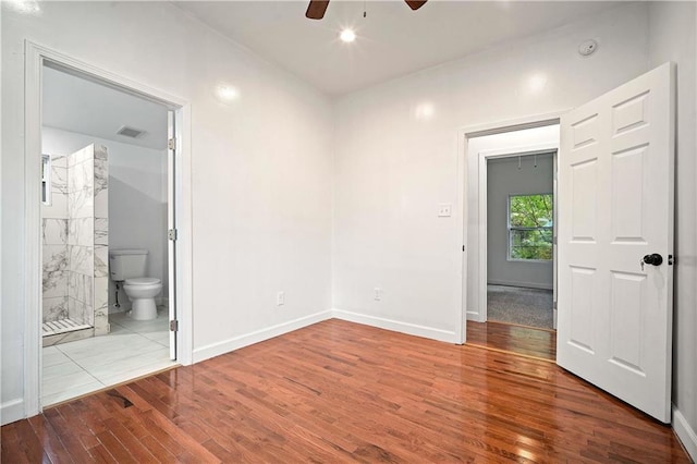 4 Straight St, Mobile, AL 36604 - unfurnished bedroom with ensuite bathroom, wood finished floors, visible vents, and baseboards