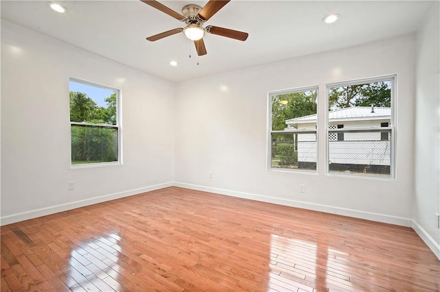 4 Straight St, Mobile, AL 36604 - empty room featuring baseboards, light wood finished floors, and a healthy amount of sunlight