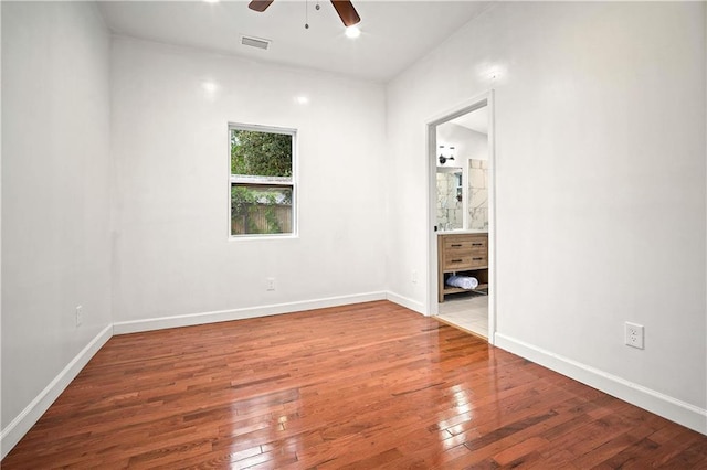 4 Straight St, Mobile, AL 36604 - unfurnished bedroom with wood-type flooring, visible vents, baseboards, and ensuite bathroom