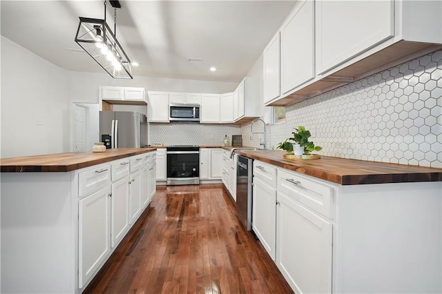 4 Straight St, Mobile, AL 36604 - kitchen featuring a sink, wooden counters, appliances with stainless steel finishes, tasteful backsplash, and dark wood finished floors