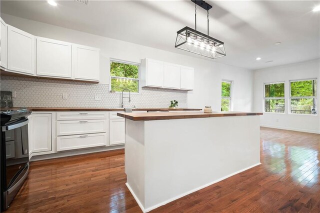 4 Straight St, Mobile, AL 36604 - kitchen featuring electric range, butcher block countertops, dark wood-type flooring, backsplash, and a wealth of natural light