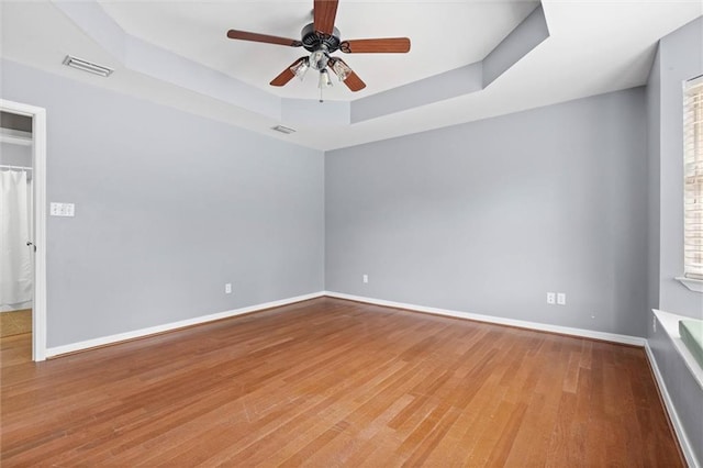405 Baker Rd, Satsuma, AL 36572 - spare room featuring a raised ceiling, wood finished floors, ceiling fan, and baseboards