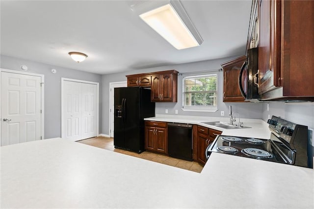 405 Baker Rd, Satsuma, AL 36572 - kitchen featuring black appliances, a sink, light countertops, baseboards, and light tile patterned floors