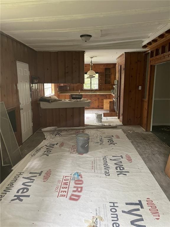 2065 Magnolia Ln, Mobile, AL 36605 - kitchen with a peninsula, wooden walls, stainless steel double oven, and hanging light fixtures