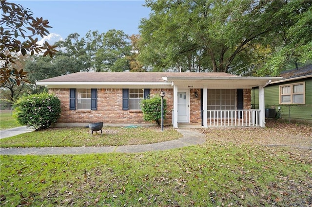 ranch-style house with a front lawn, covered porch, and central AC unit