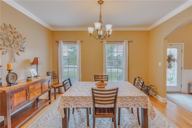 10808 Legacy Ln, Mobile, AL 36608 - dining area with arched walkways, a chandelier, light wood finished floors, and crown molding