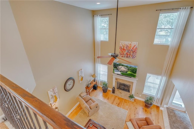 10808 Legacy Ln, Mobile, AL 36608 - living room with a fireplace with flush hearth, ceiling fan, a high ceiling, wood finished floors, and recessed lighting