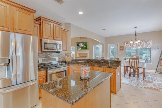 10808 Legacy Ln, Mobile, AL 36608 - kitchen with stainless steel appliances, arched walkways, a peninsula, a center island, and light tile patterned floors