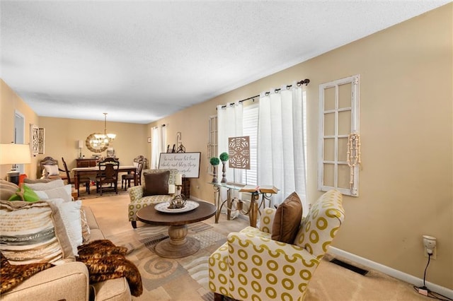 living room featuring a chandelier and light colored carpet