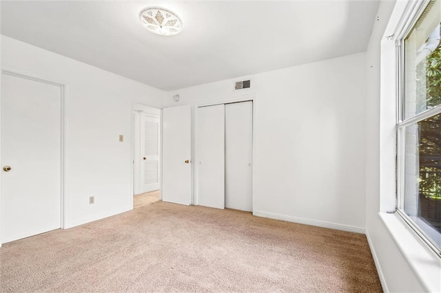 unfurnished bedroom with light carpet