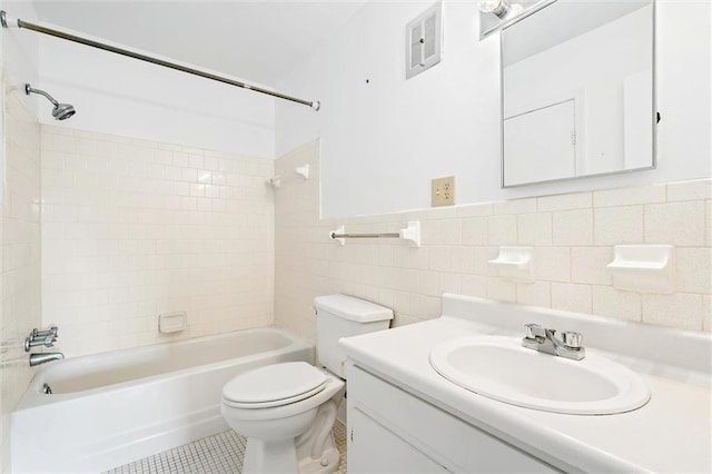 full bathroom featuring vanity, tiled shower / bath combo, tile walls, toilet, and decorative backsplash