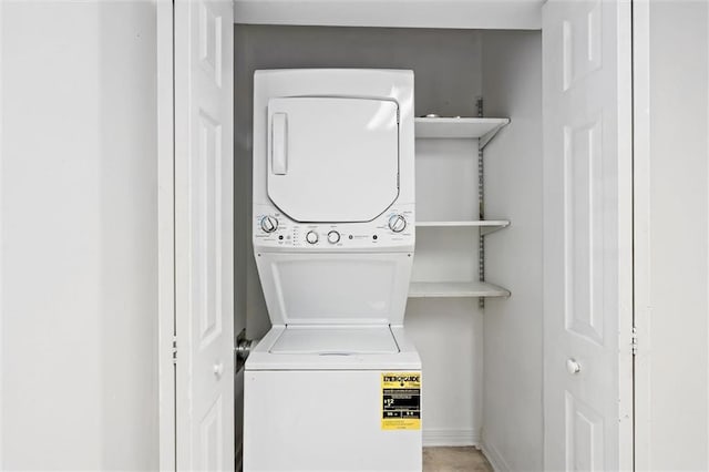 clothes washing area with stacked washer and dryer