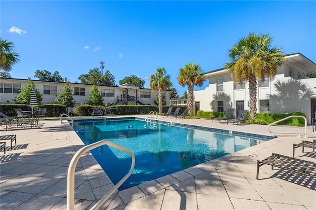 view of pool featuring a patio area and sink