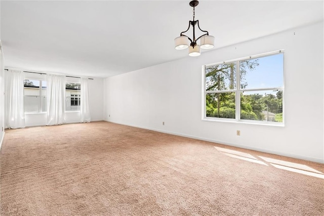 unfurnished living room with a notable chandelier and carpet flooring